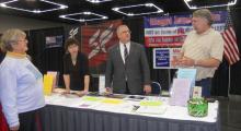 Lots of visitors to the OFIR booth as Representative Mike Nearman and Jerry Kendoll answer questions.