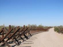 Border fence vehicle barrier